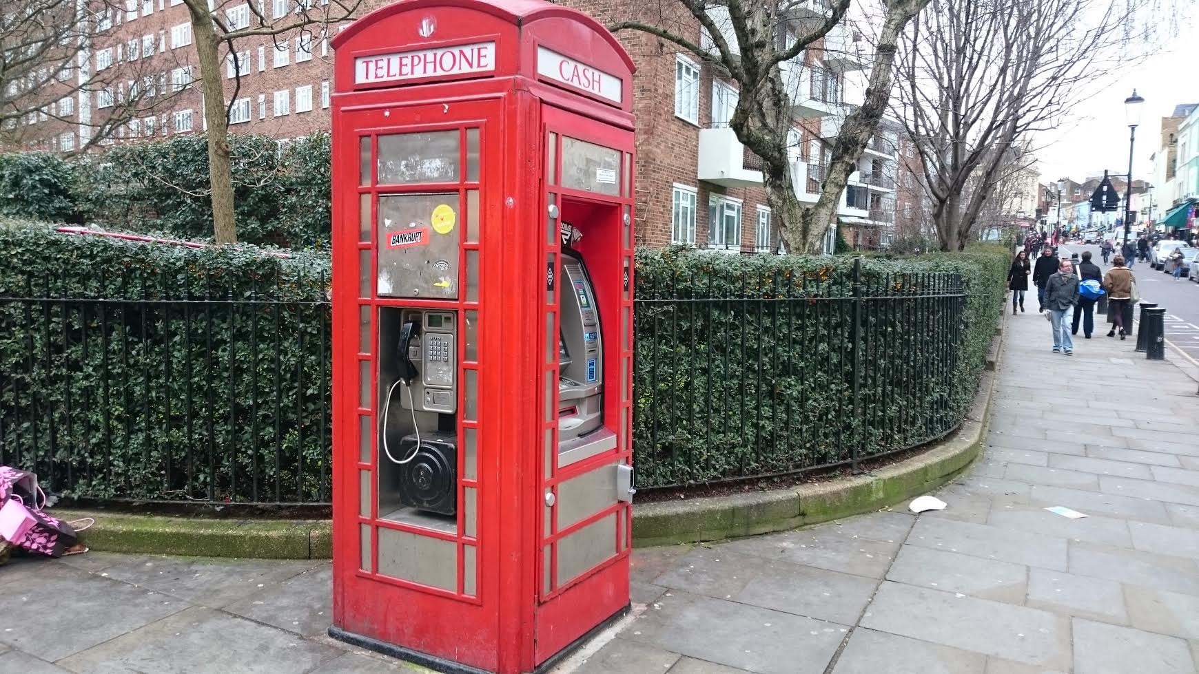 BT red telephone box converted to cash machine and public phone.