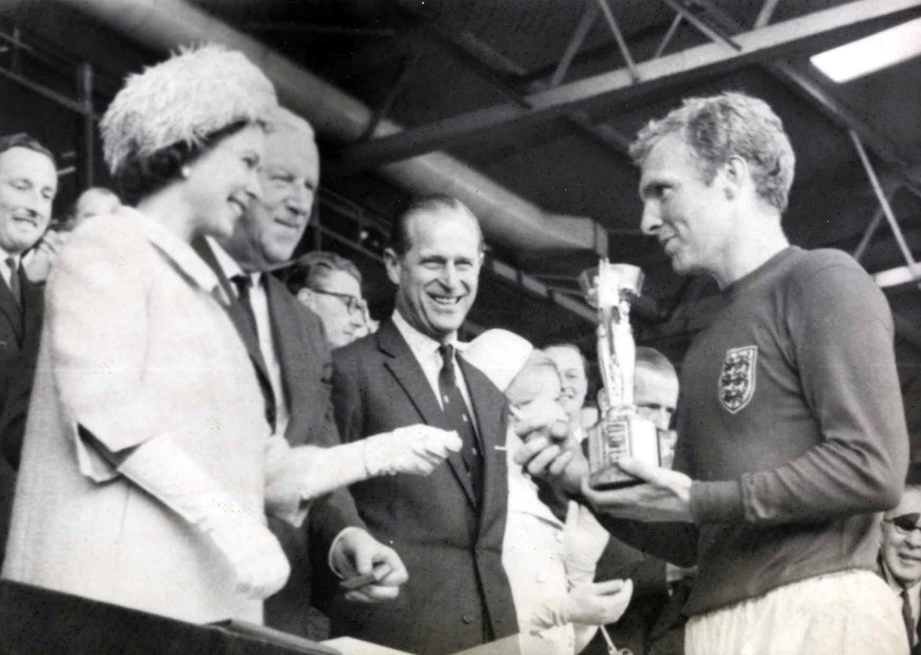Englands-World-Cup-triumph-in-1966-as-Captain-Bobby-Moore-receives-the-Jules-Rimet-Trophy-from-Her-Majesty-the-Queen-at-Wembley