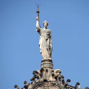 ictoria Terminus dome topped by a statue of progress holding a torch