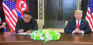 Kim Jong-un and Trump signing the historic agreement