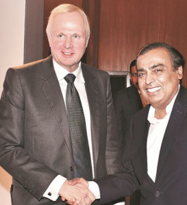 Bob and Mukesh handshake after signing JV agreement