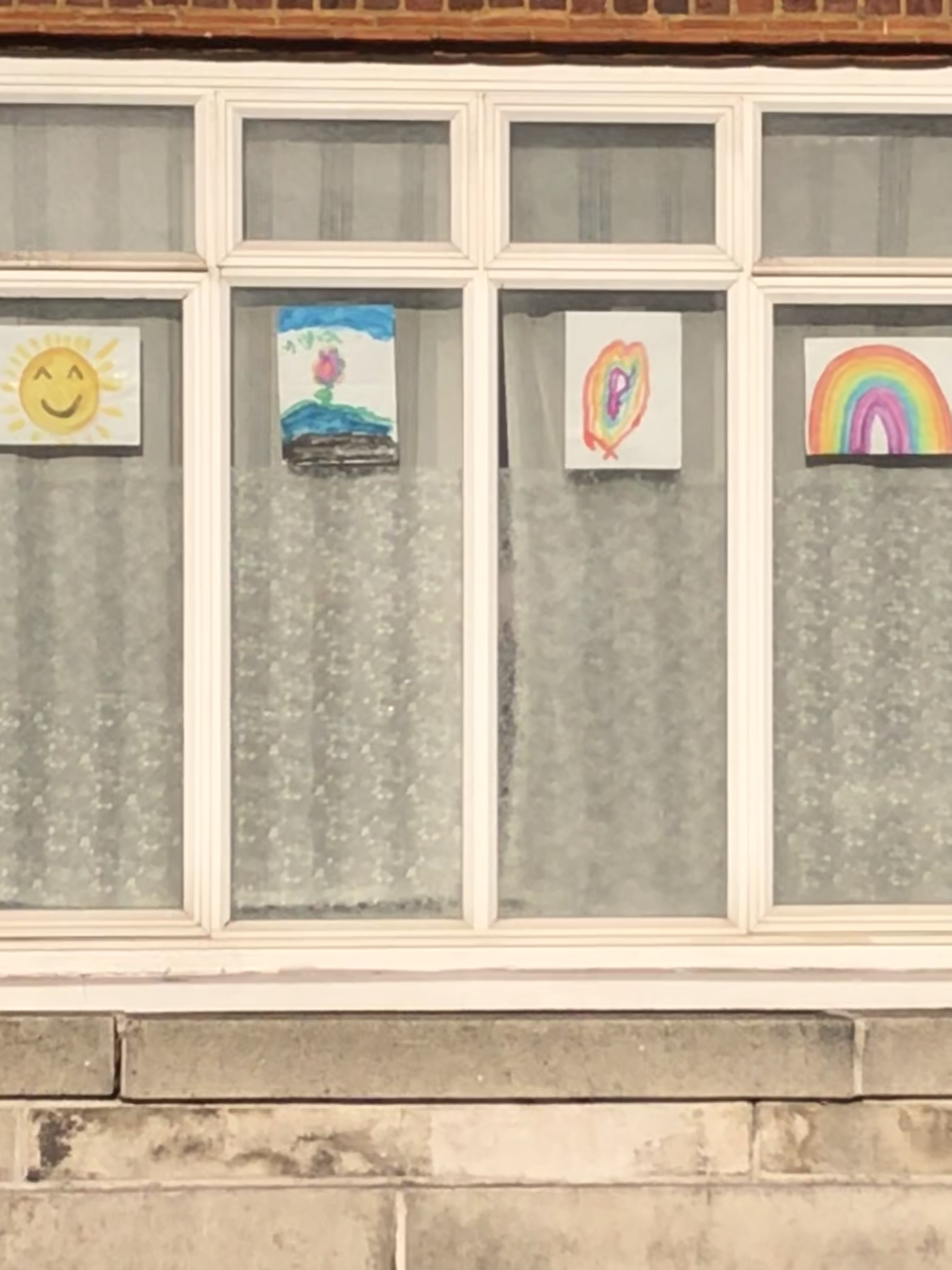 London Lockdown children occupying themselves  by drawing rainbows and displaying on their windows
