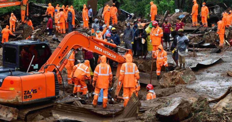 Rescue workers sifting through rubble after landslide