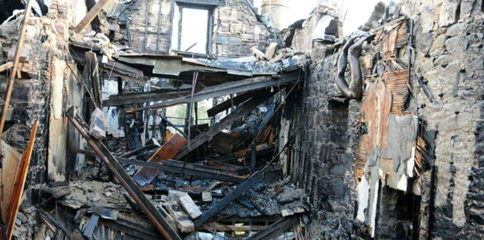 Charred remains of the hotel reception and concere's desk where fire started