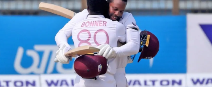 Double centurian Mayers gets a hug from Bonner