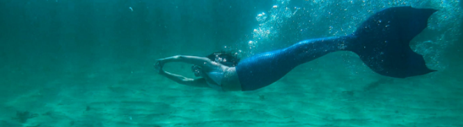 Kate MacLeod mermaid swimming in the locs of Western Isles