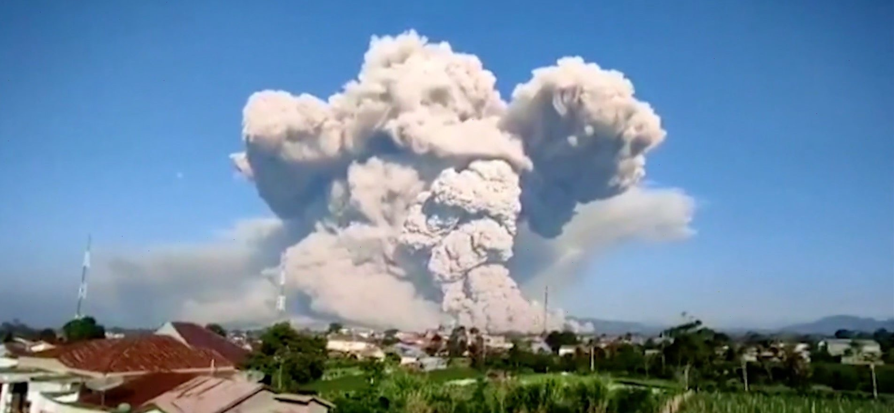 Mount Sinabaug erupts