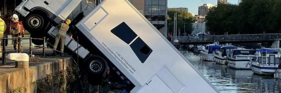 A HGV truck carrying costumes for BBC is half submerged in the Bristol Harbour