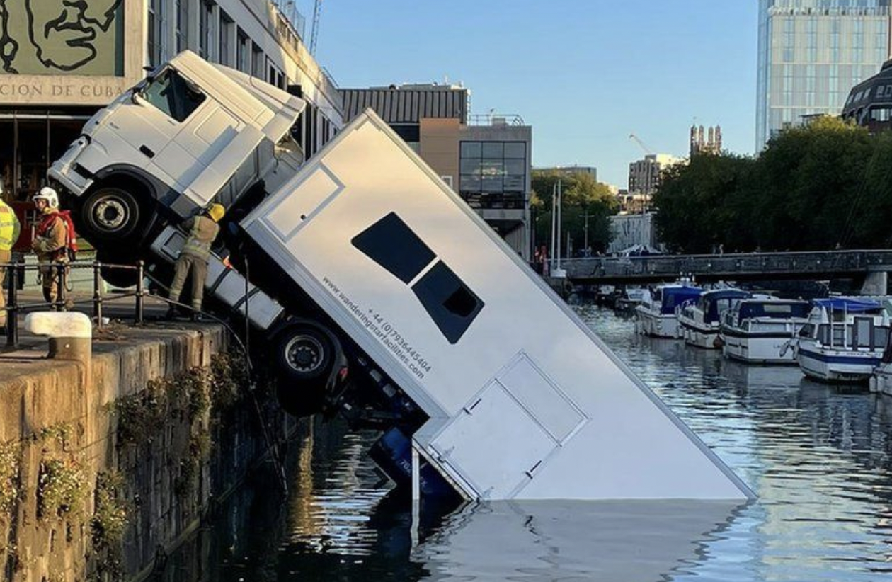 A HGV truck carrying costumes for BBC is half submerged in the Bristol Harbour