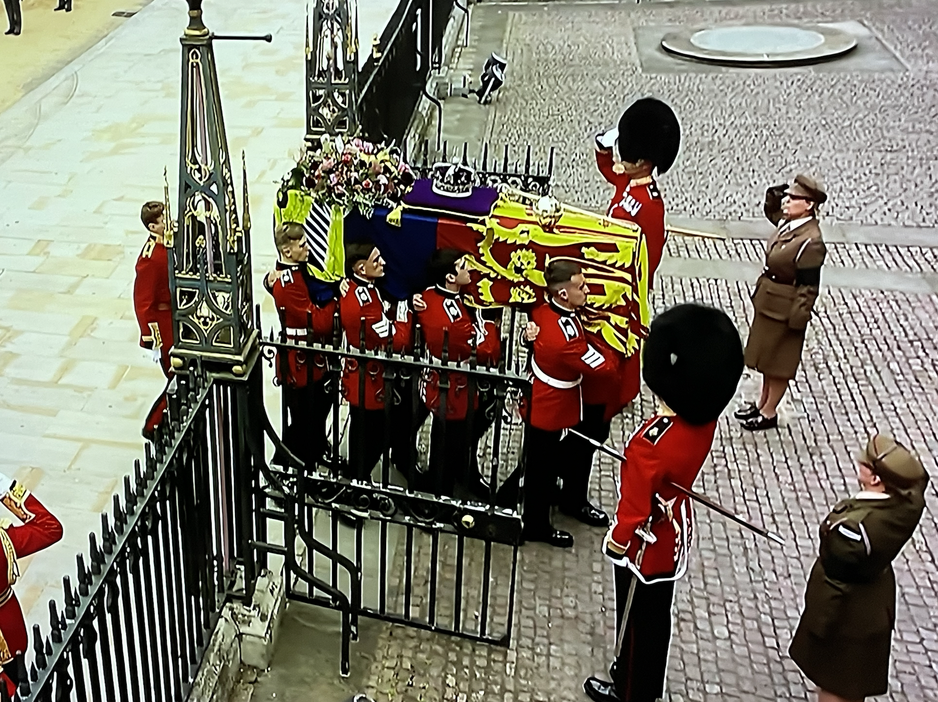 Queens Coffin passing the gates of Westminster Abbey,
