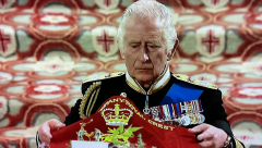 King Charles III palcing the blanket
